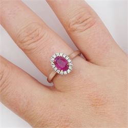 18ct white gold oval cut ruby and round brilliant cut diamond cluster ring, hallmarked, ruby approx 0.85 carat, total diamond weight approx 0.15 carat