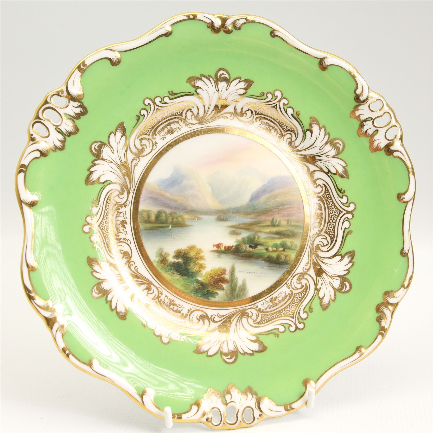 19th century Davenport cabinet plate, centrally painted with a view of Crummock & Buttermere, within a green border, titled and numbered 1247 verso, D25.5cm, Davenport Longport cabinet plate, 19th century rococo influence inkwell, porcelain bowl retailed by T.Goode & Co., together with a Newhall teapot stand, decorated in the imari pallette, patten no. 1154 L18.5cm (5)