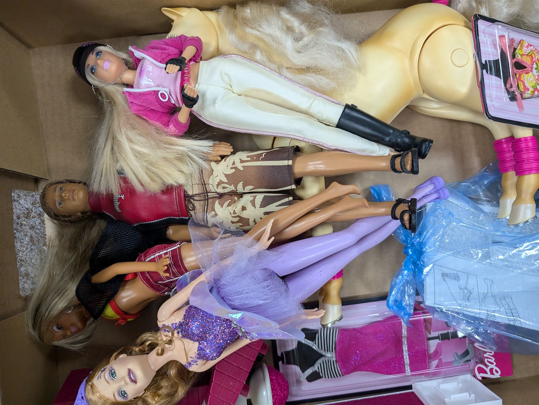 Collection of Barbie dolls, clothes, horse, stable and accessories, including, together with a Mattel Barbie yellow Volkswagen Beetle, with mobile phone remote control