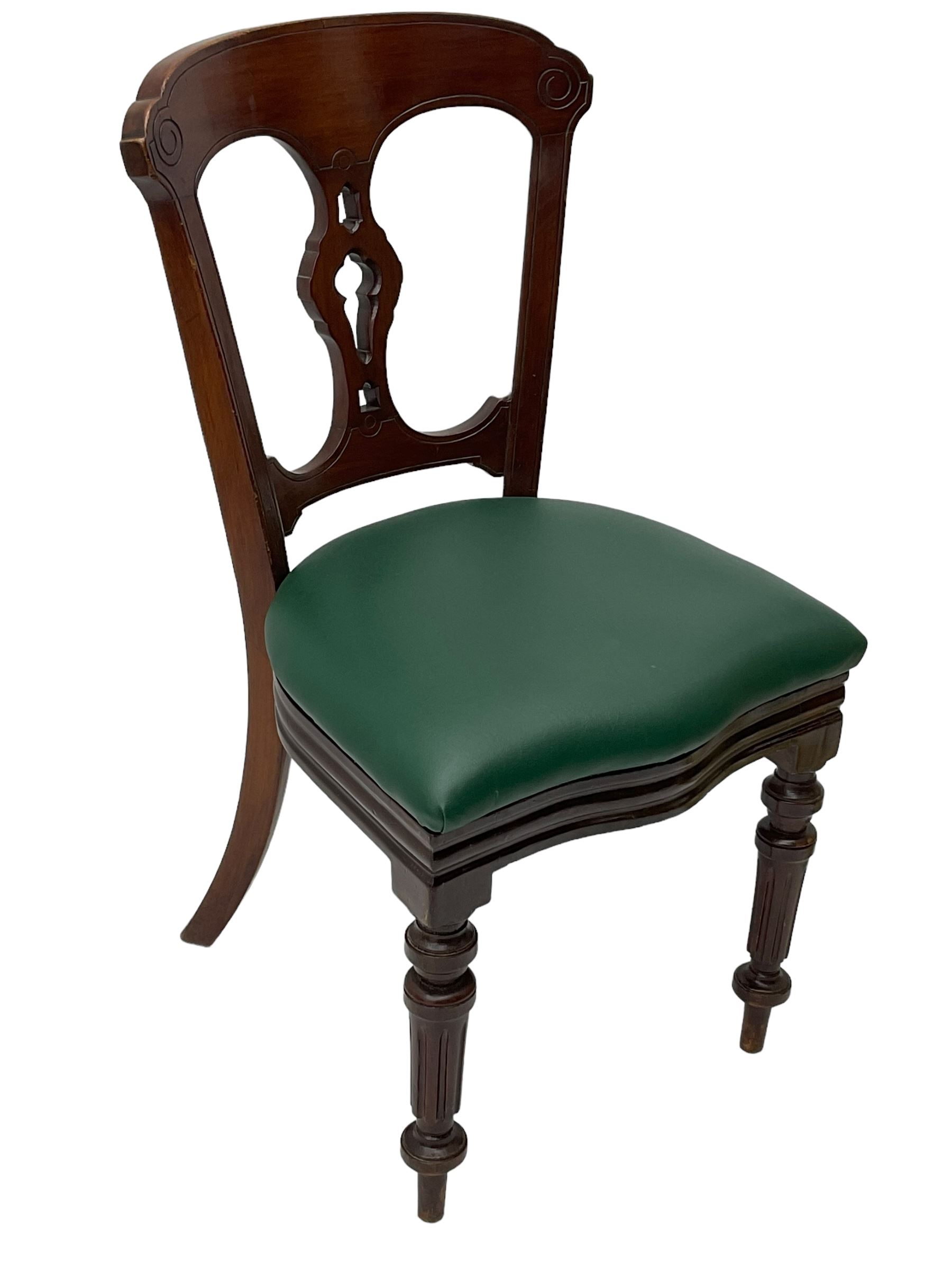 Matched set of twelve Victorian mahogany dining or boardroom chairs, the shaped cresting rail decorated with scrolled decoration, upholstered drop-on seats upholstered in green fabric, on turned supports  