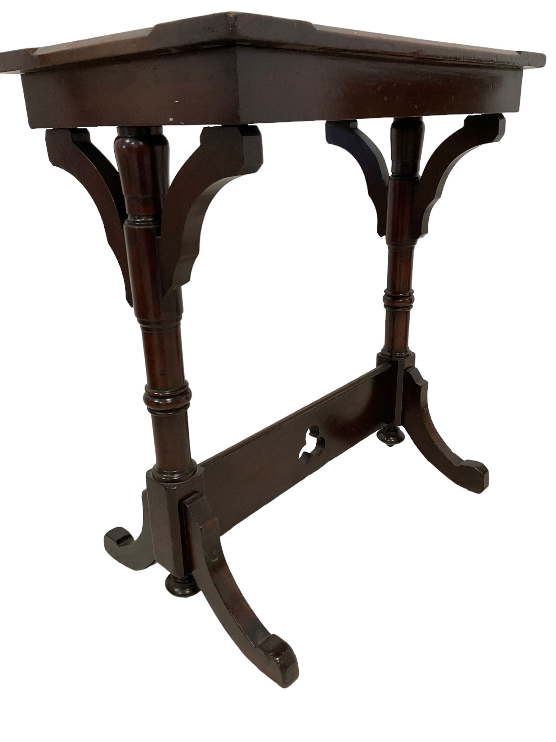 Late Victorian walnut ecclesiastical side table, rectangular top with stop chamfered edge, on turned supports united by rectangular stretcher pierced with trefoil, on splayed feet 