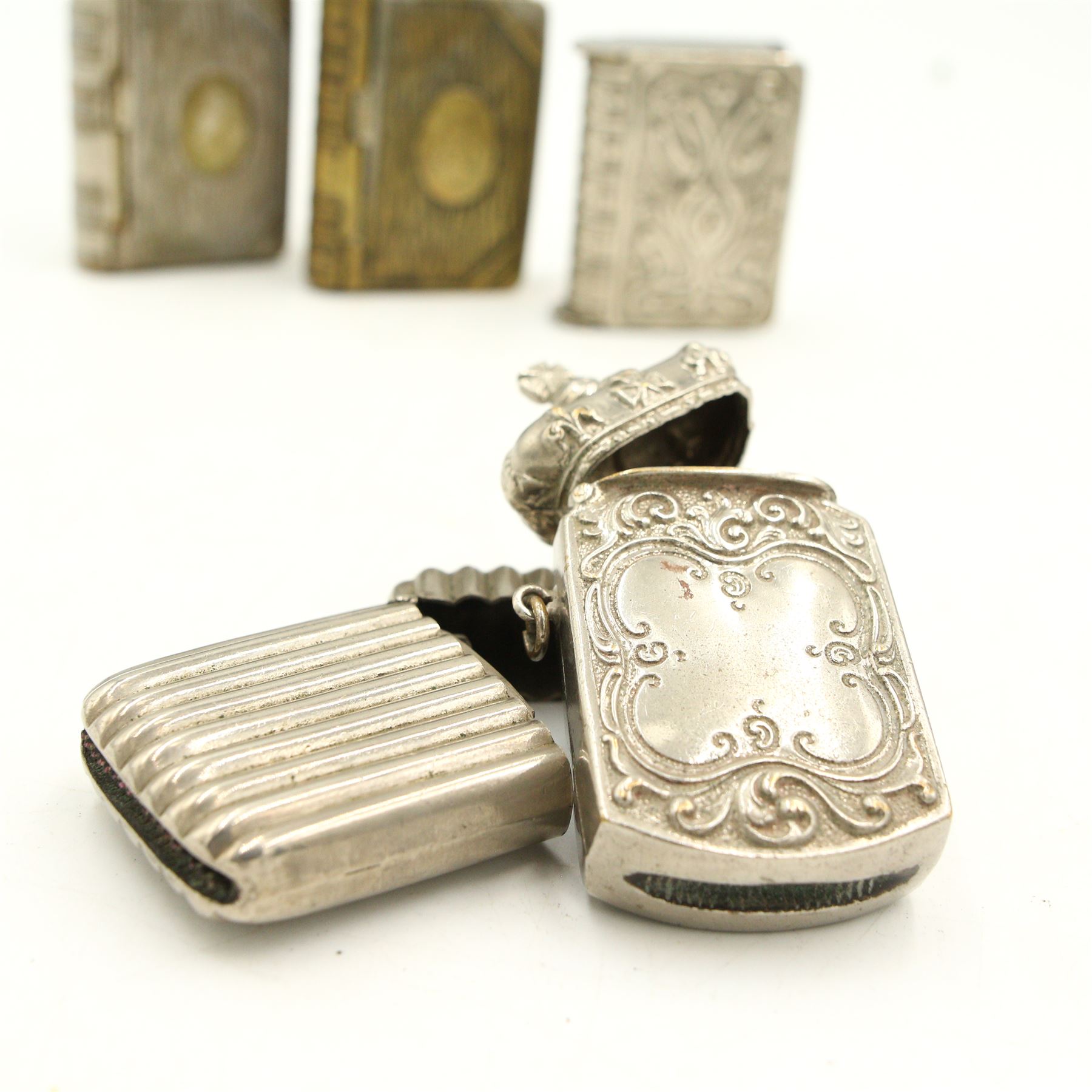 Victorian and later silver-plated vesta cases including three formed as books, another with a crown form hinged cover and others (13)