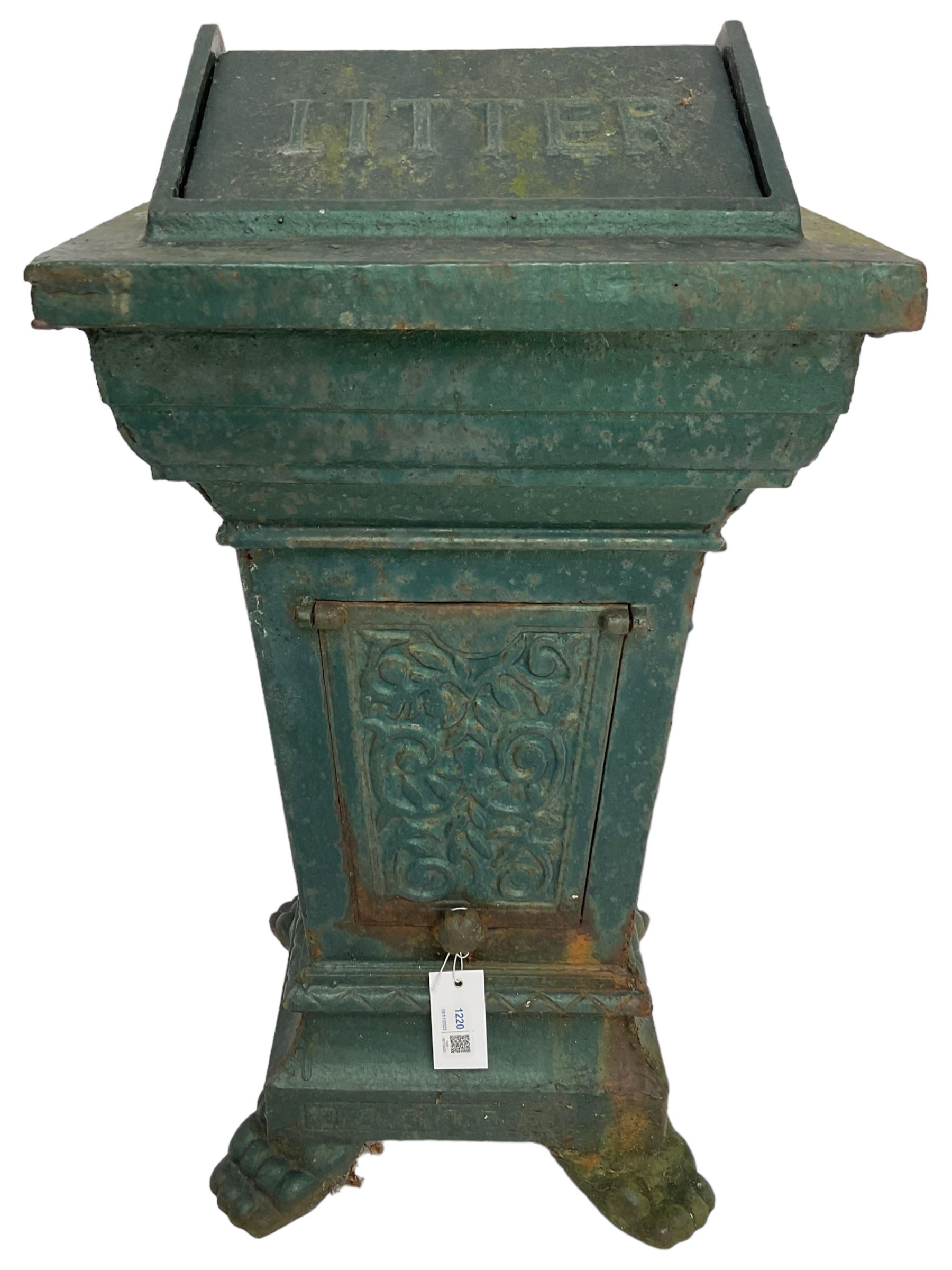 Early 20th century cast iron litter bin, square tapering form with scrolling foliate decoration, on paw feet