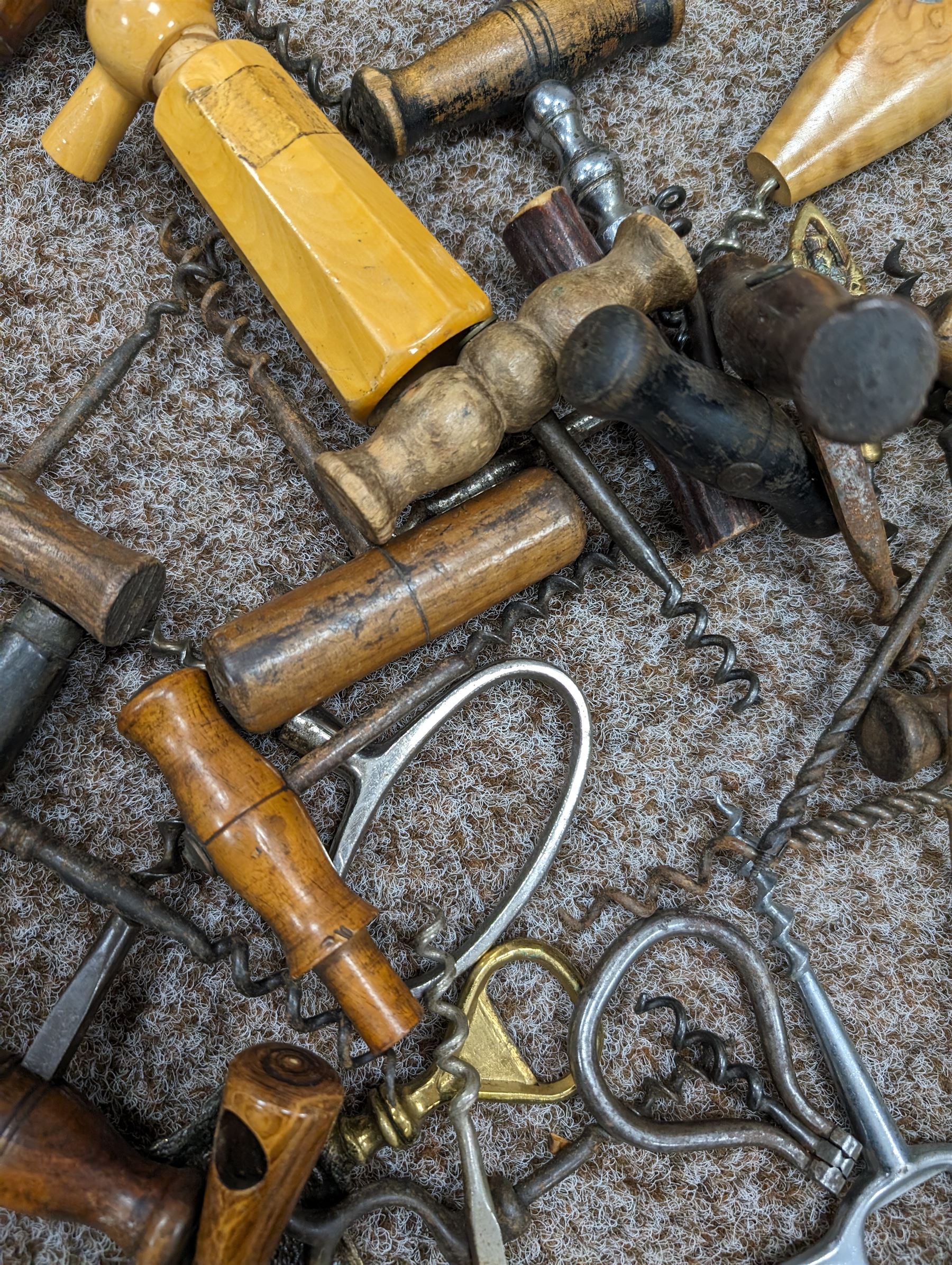 Collection of approximately fifty seven corkscrews, including turned wooden and metal examples