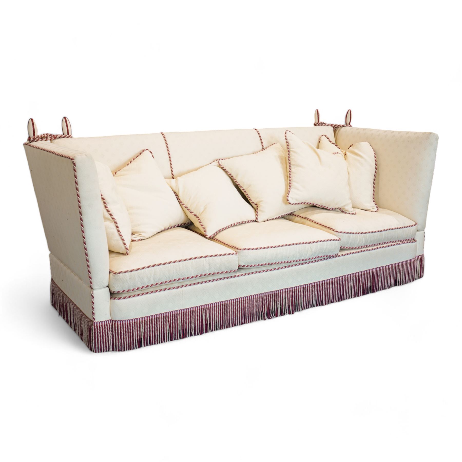 Grande Knole four-seat sofa, upholstered in geometric lozenge pattern cream fabric with burgundy and cream twist piping and fringe, on castors