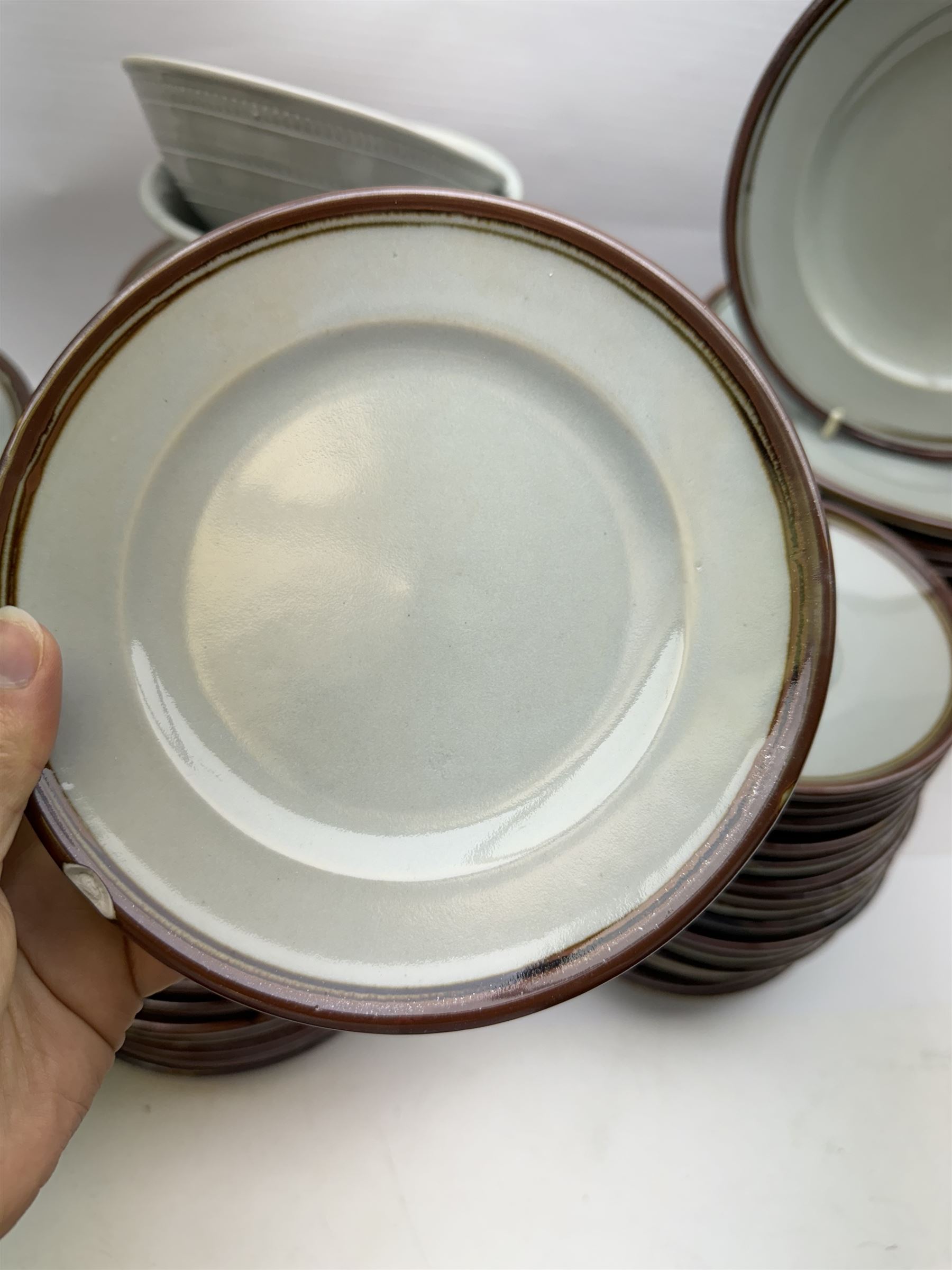 20th century celadon dinner service with iron rim, comprising nineteen dinner plates 26.5cm, twenty-four side plates D24cm, twelve varying bowls, twenty-two tea plates and fifteen saucers 