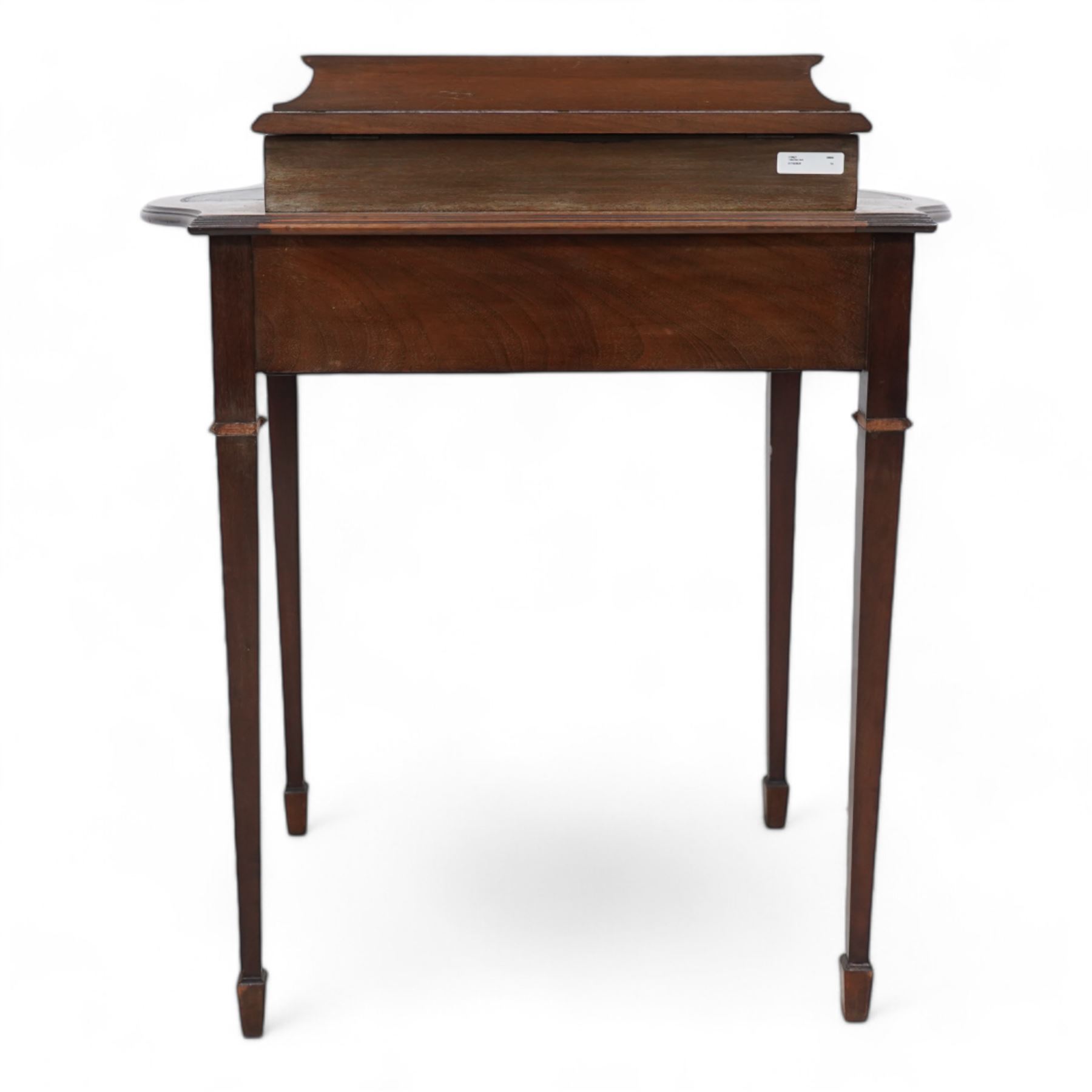 Edwardian mahogany writing desk, raised hinged compartment fitted with divisions, shaped and moulded top with leather inset, fitted with single drawer, on fluted square tapering supports with spade feet