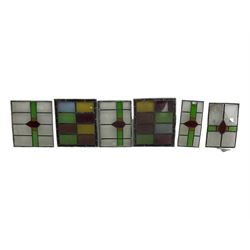 Six leaded stained glass window panes, largest measuring - 46cm x 41cm