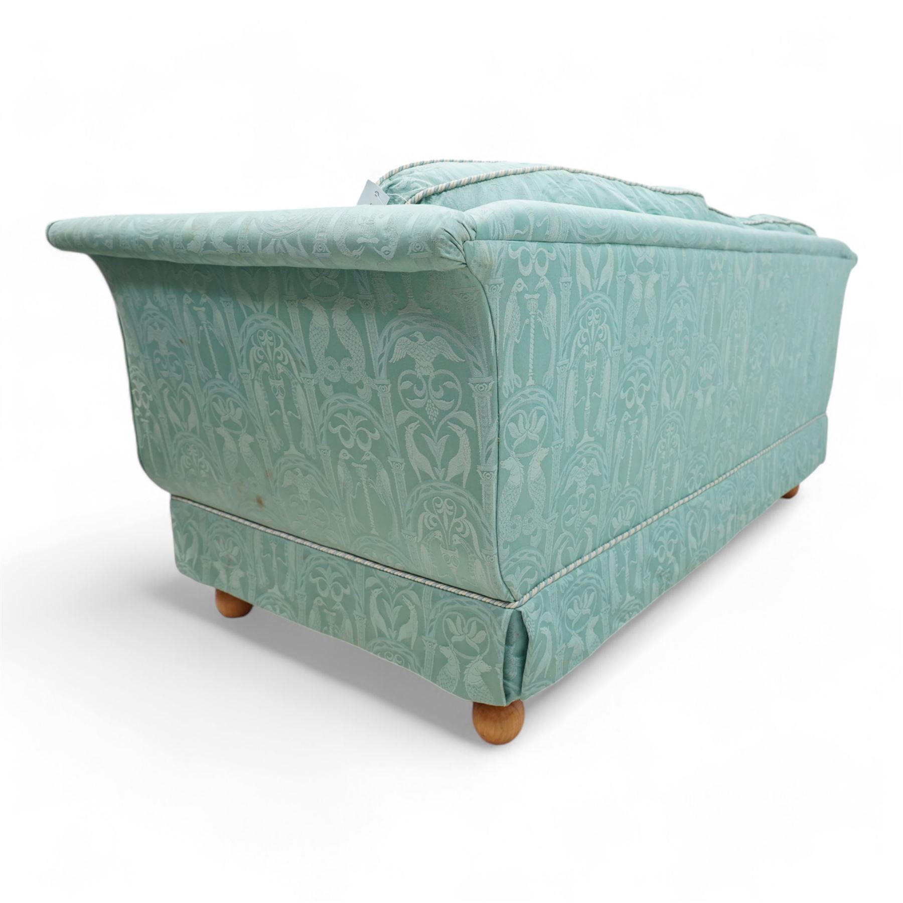 Regency shaped hardwood-framed two-seat sofa, upholstered in turquoise fabric decorated with arches enclosing birds of paradise and seahorses, on turned bun feet 