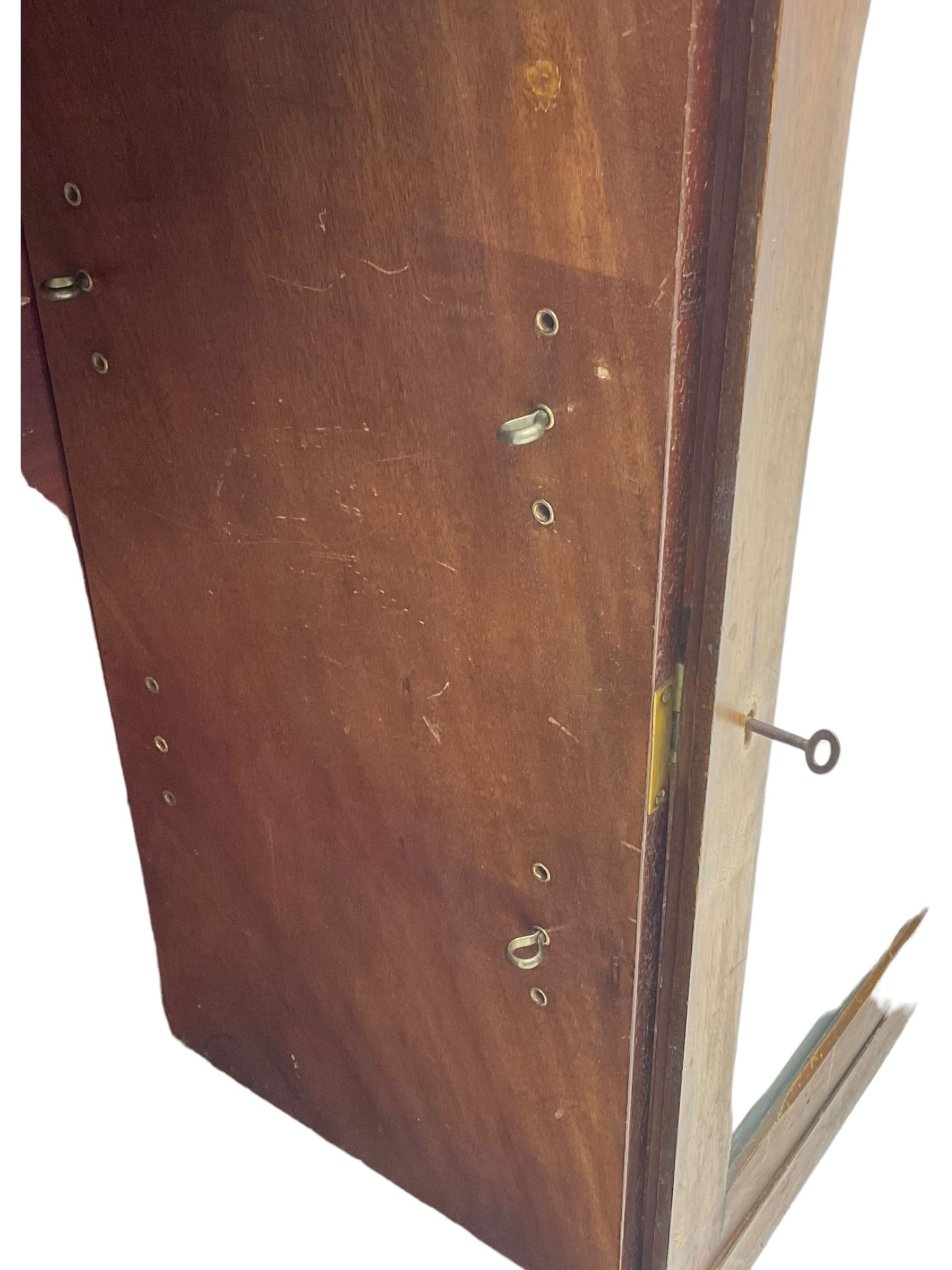 Early 20th century mahogany bookcase, rectangular top over two glazed doors, fitted with four adjustable shelves, on turned bun feet 