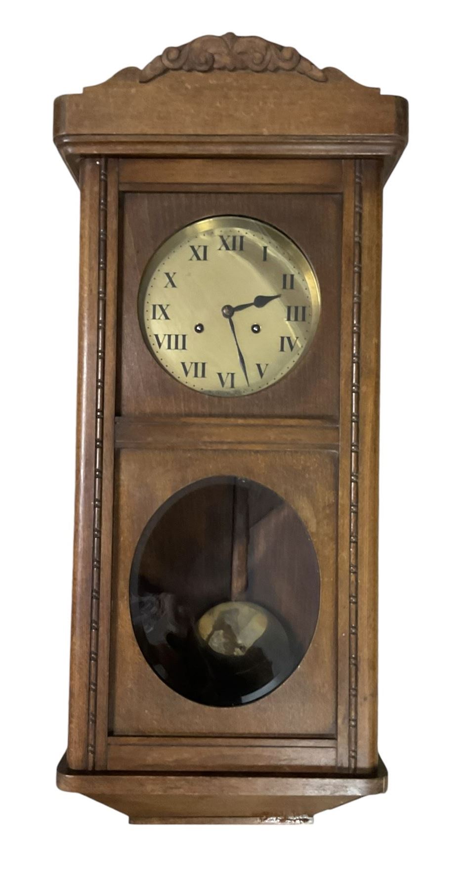 Two train oak cased wall clock, striking the hours on a coiled gong. With pendulum and key.