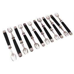 Set of twelve French silver oyster forks, the three prong forks each within foliate mounts with black Bakelite type handles, with wood effect detailing and silver finials, the prongs marked with Minerva's head for 800 standard and weevil import mark
