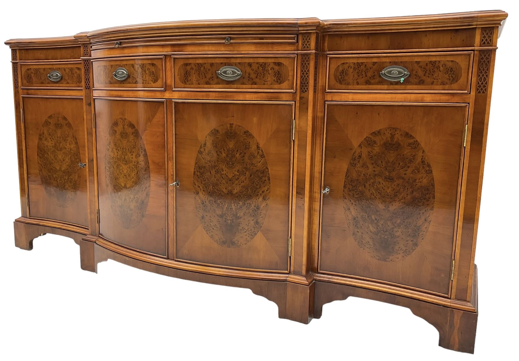 Wade - Georgian design yew wood bow-fronted sideboard, projecting moulded top over four cockbeaded frieze drawers, the central two with pull-out slides, four cupboards below with figured veneers, raised on bracket feet