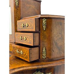 19th century French figured walnut Bonheur de Jour or writing desk, the upper section with brass gallery over mirror glazed cupboard and a combination of drawers, shaped and moulded top with leather inset and satinwood band, fitted with single drawer, on cabriole supports, inlaid throughout with scrolling foliate decoration in boxwood, ornate cast brass mounts 