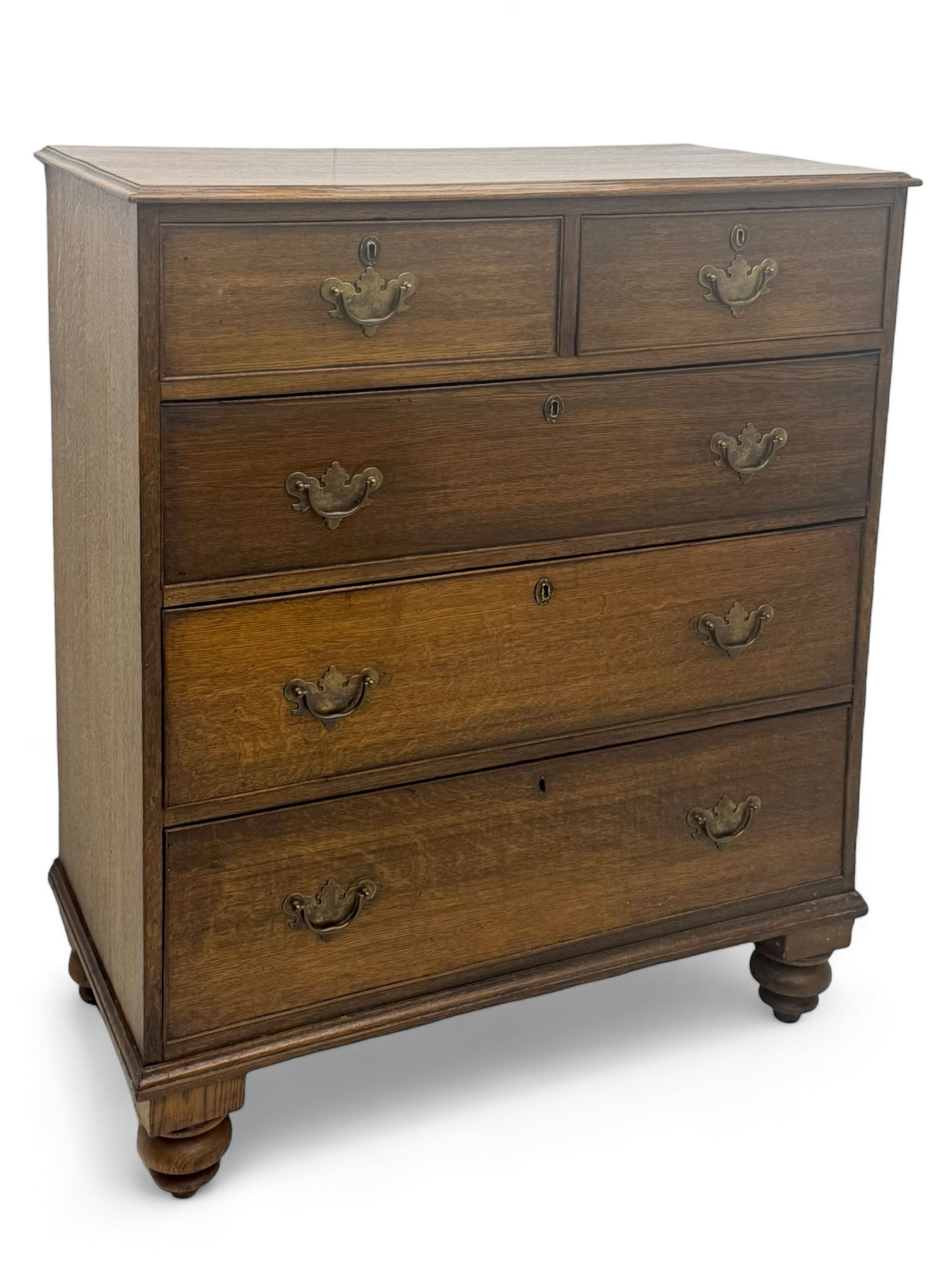 George III oak chest, rectangular top with moulded edge over two short and three long graduated drawers, each with brass escutcheons and shaped backplate handles, on turned bun supports 