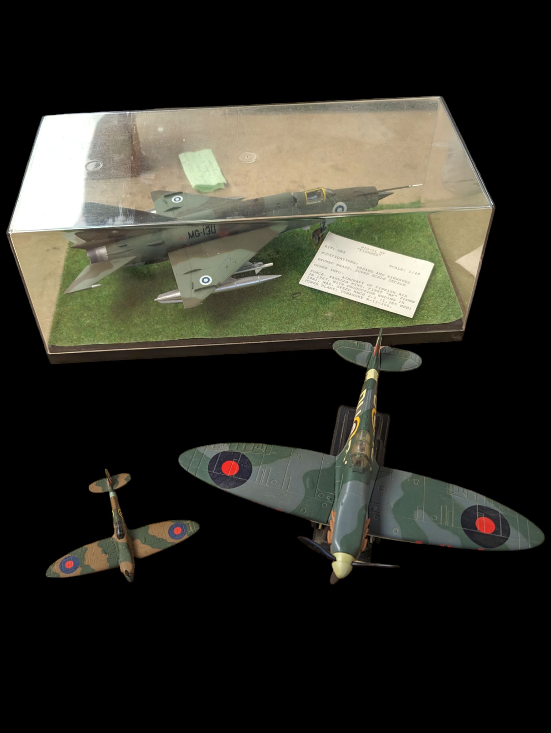 OEZ kitbuilt model of a 'Fishbed' Finnish aircraft, in ERTL display box, together with an Air Signature model of a Spitfire and a Corgi model of a Spitfire