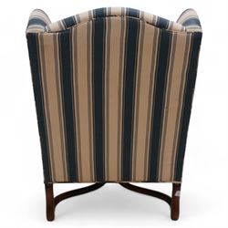 Georgian design wingback armchair, upholstered in blue and cream striped fabric, on shaped supports united by serpentine x-framed stretchers 