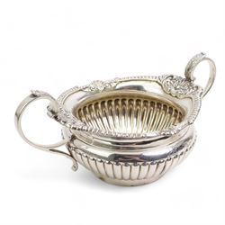 Late Victorian silver two handled sugar bowl with shell moulded and gadrooned border and leaf capped handles, crest of a lion passant and half body fluted decoration and matching milk jug London 1895 Maker Messrs Barnard (2)