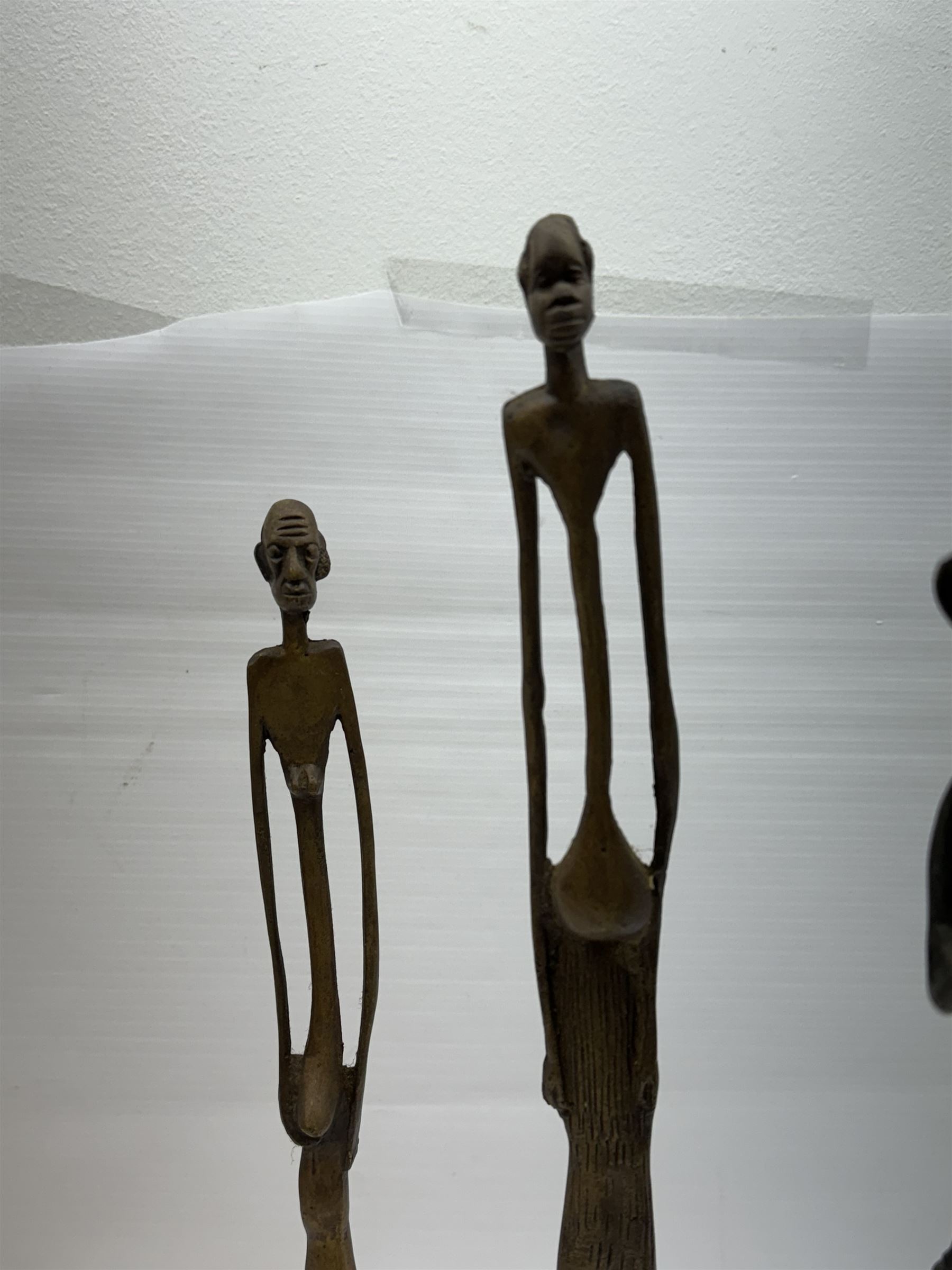 Five bronzed tribal figures, of elongated form, tallest H18cm