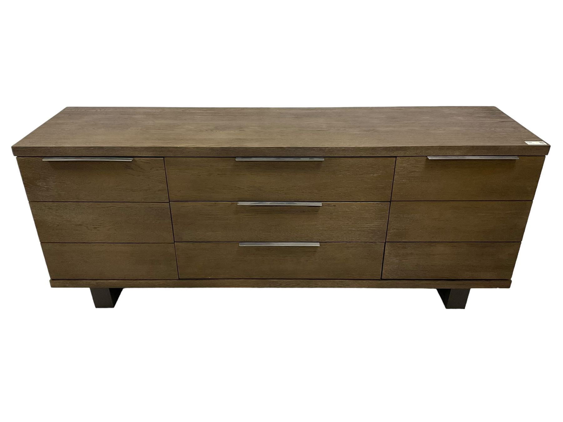 Contemporary dark oak finish sideboard, three central drawers flanked by single cupboards, on angular black finish metal supports 