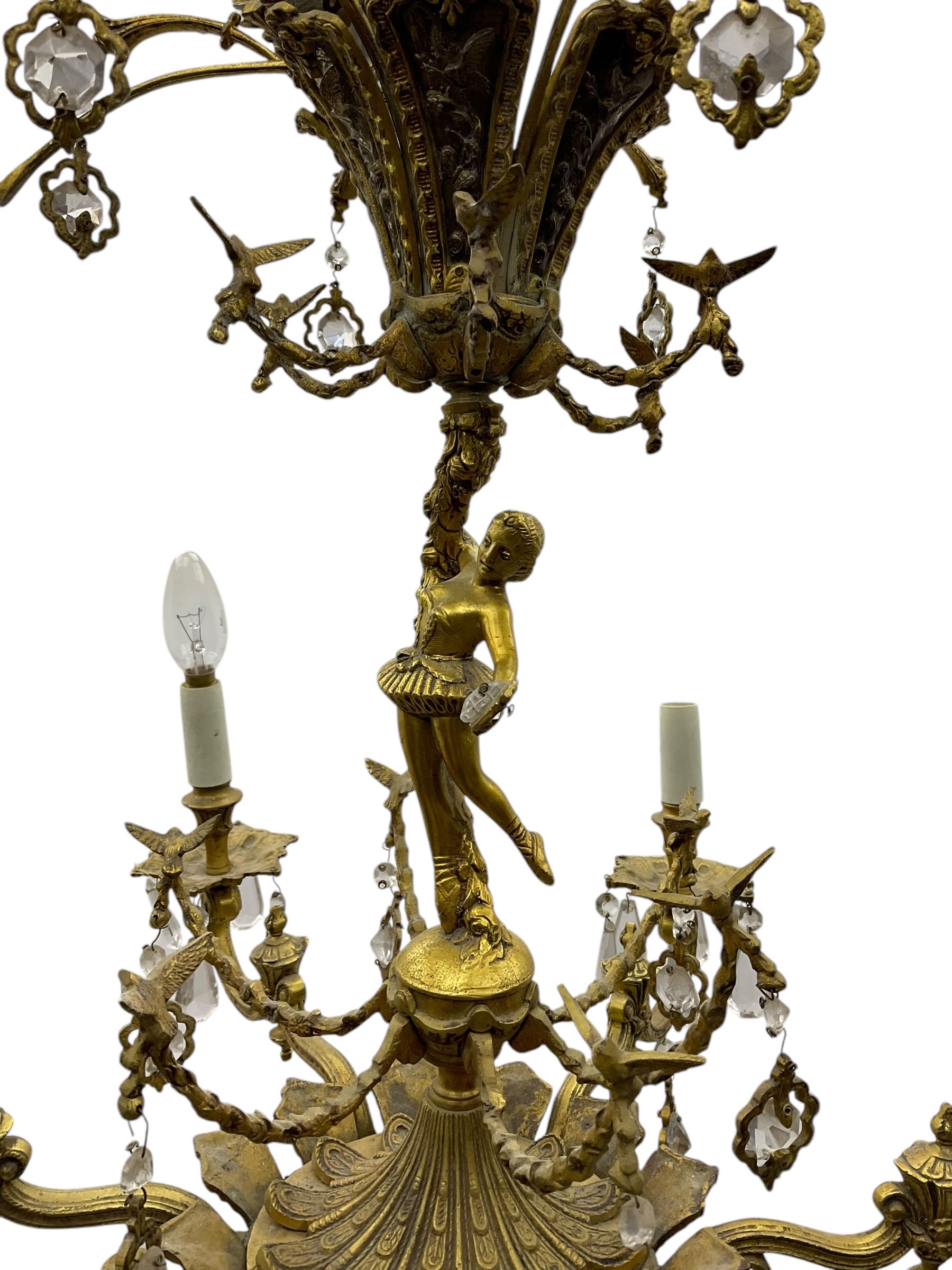 Gilt metal six branch ceiling light, the central stem modelled as a ballerina, decorated with glass pendants 