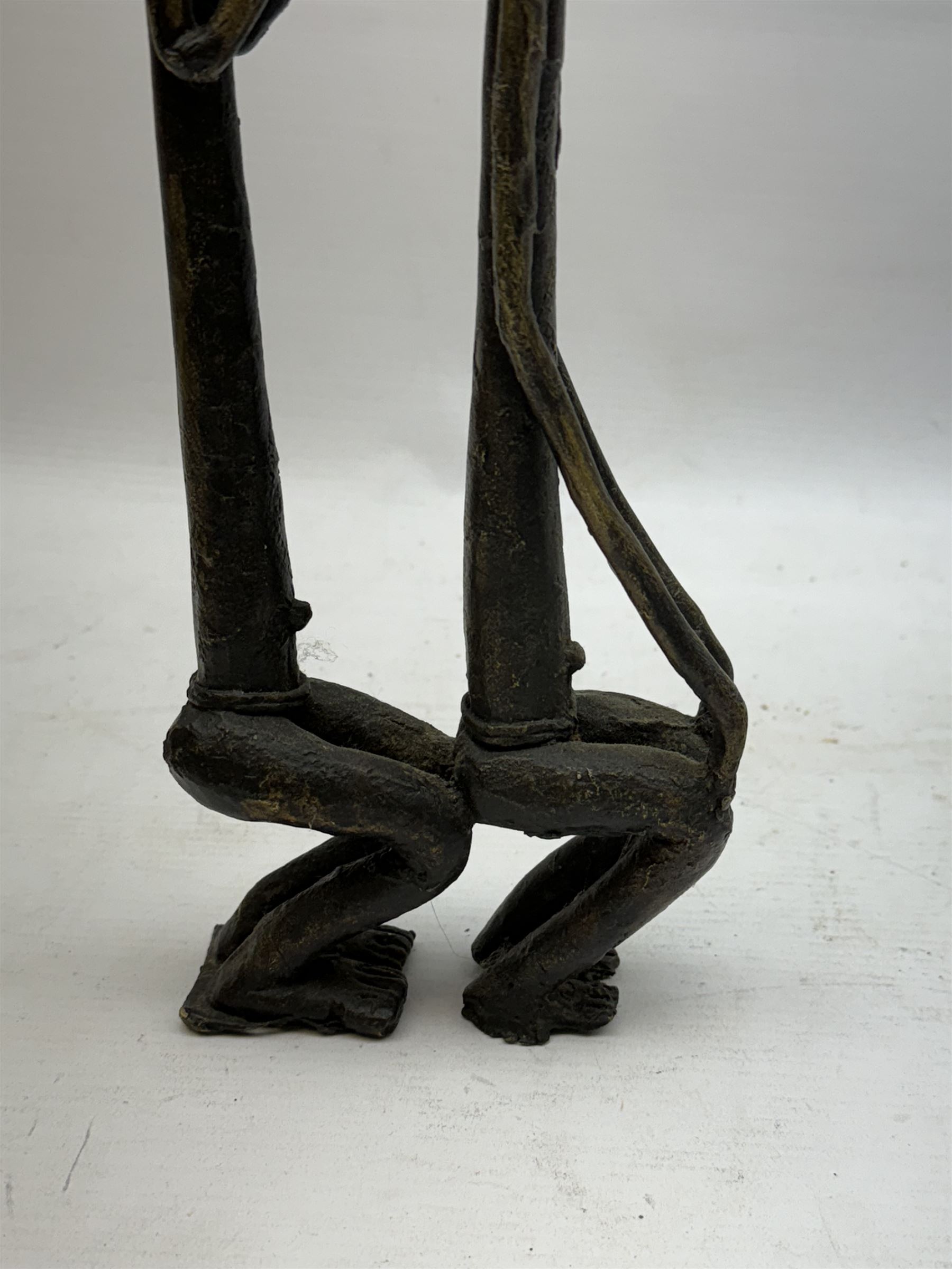 Five bronzed tribal figures, of elongated form, tallest H18cm