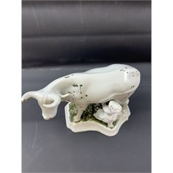 19th century Delft figure group depicting a milkmaid milking a cow, H17.7cm