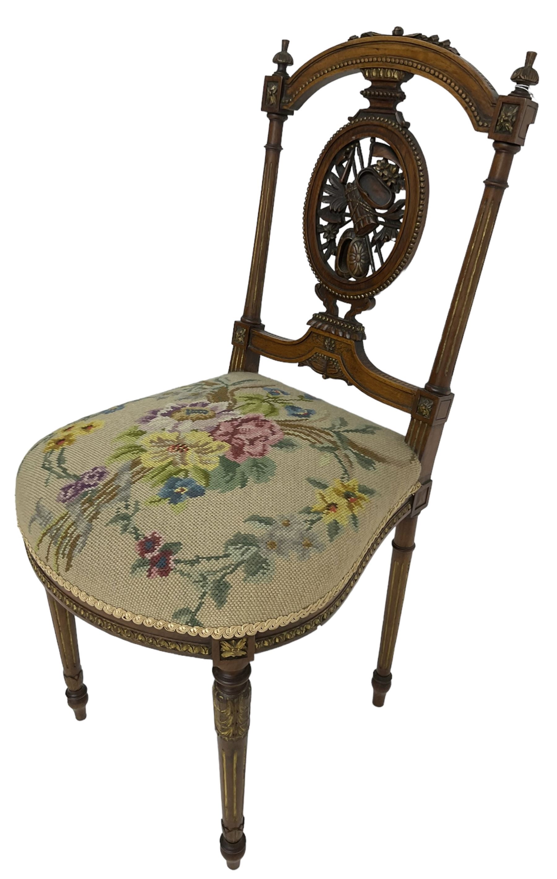 Late Victorian walnut side chair, arched cresting rail over carved and pierced splat depicting baskets and foliage, floral needle work upholstered seat, on acanthus carved and fluted turned supports