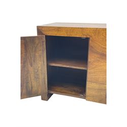 Contemporary Dakota mango wood sideboard, plain rectangular top over three central drawers flanked by cupboards with shelving, each with square pulls, raised on stile supports