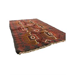 Baluchi red and blue ground rug, the field decorated with large six Gul motifs