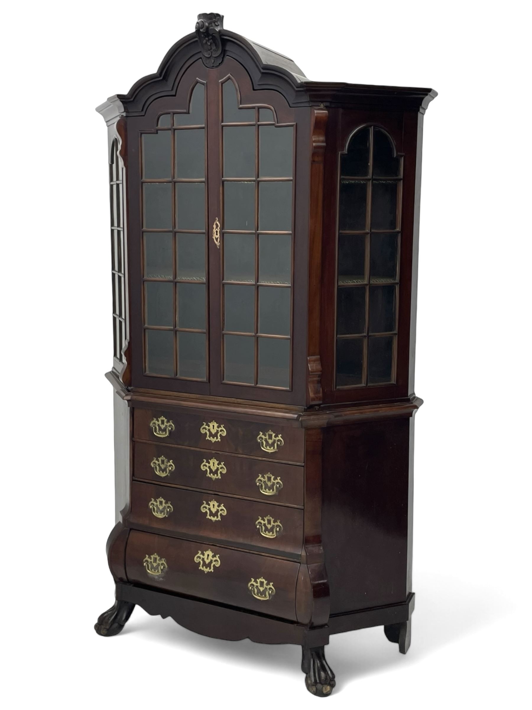 19th century Dutch mahogany vitrine on chest, shaped moulded pediment with central C-scroll and flowerhead carved mount, enclosed by two astragal glazed doors, the interior fitted with fabric lined shelves, four graduating long drawers below, on ball and claw carved feet 