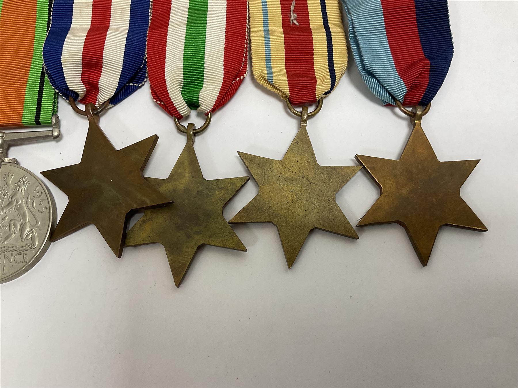 WWII group of six medals comprising 1939-45 Star, The Africa Star, The Italy Star, France and Germany Star, Defence Medal and War Medal 1939-45, awarded to 7899181 RAC C.W Hughes, together with two chevrons and ephemera relating to Charles William 'Bill' Hughes including Soldier's Release Book, photographs, certificates of transfers etc 