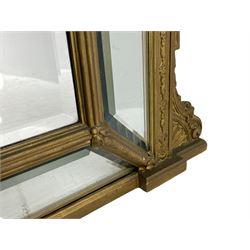 19th century giltwood and gesso cushion framed mirror, the frame decorated with trailing flower heads, fitted with fan and scroll decorated brackets, bevelled glass plates