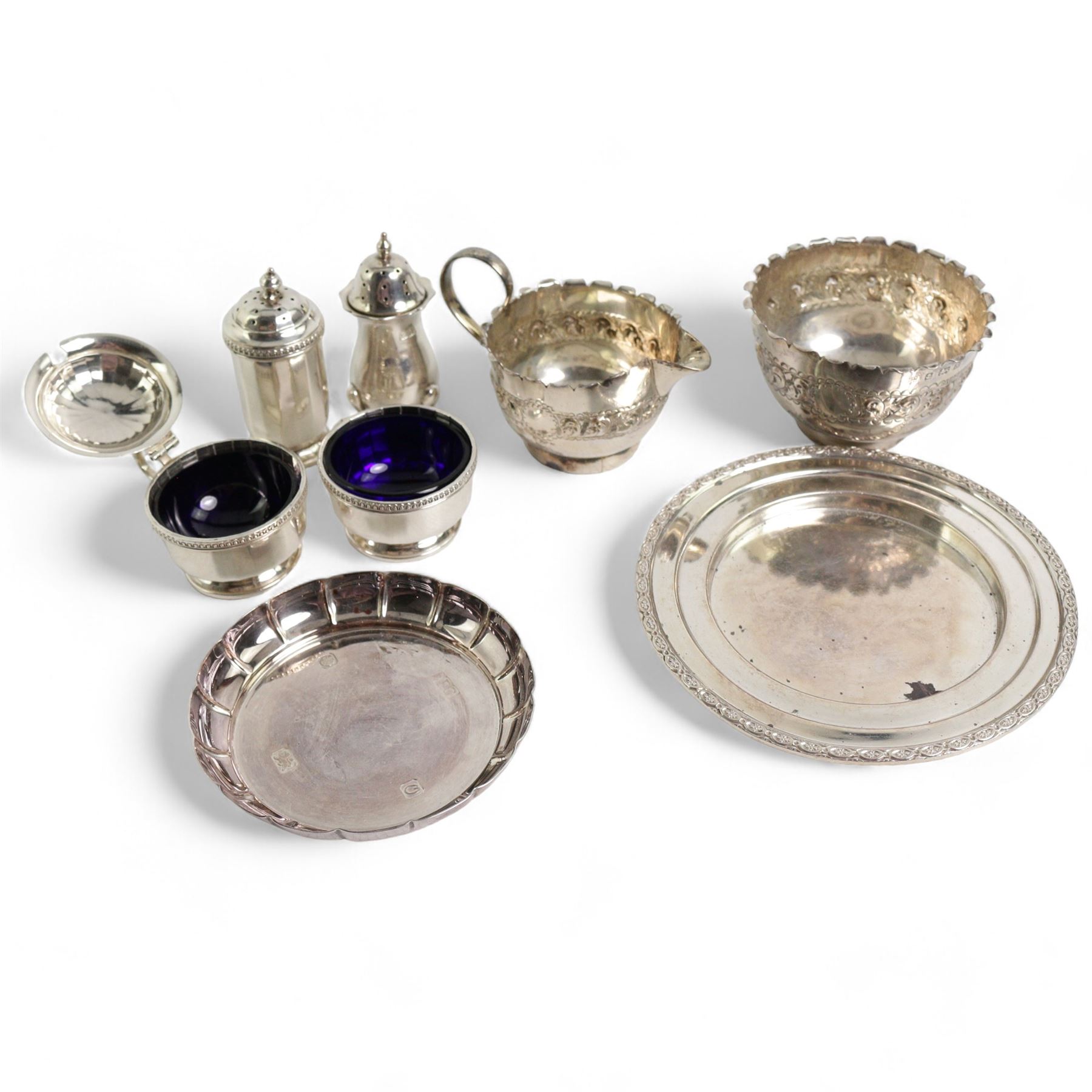 Late Victorian silver sugar bowl and matching cream jug with crimped rims Birmingham 1900, silver three piece condiment set, silver pepperette and two silver saucer dishes 