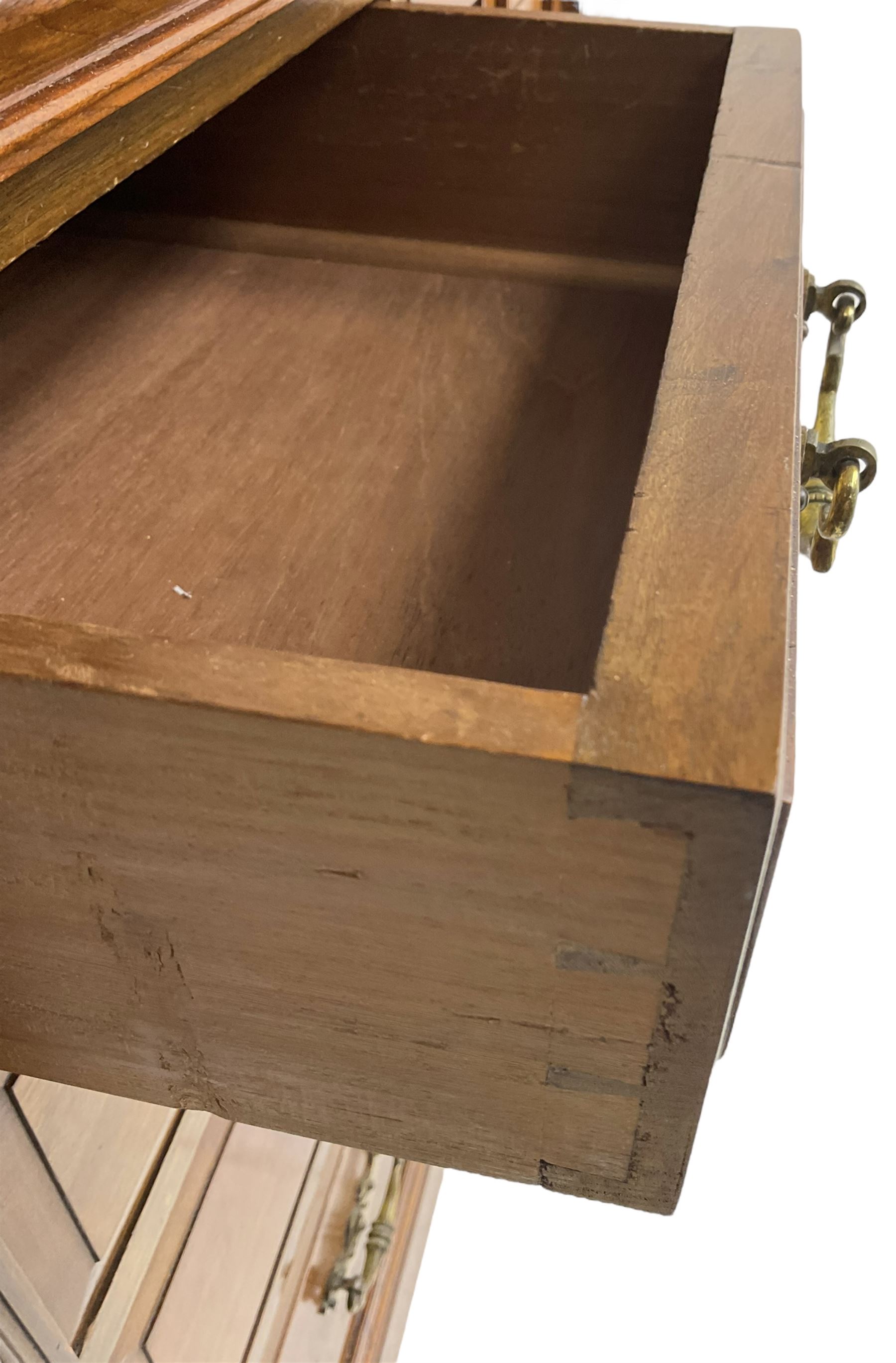 Edwardian mahogany dressing chest, raised triple mirror back with bevelled plates and fluted decoration over two trinket drawers, the base fitted with two central cupboards flanked by four graduating drawers to each side