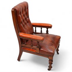 Late Victorian walnut matched two-piece salon suite upholstered in rust buttoned leather - open armchair, reed moulded frame and turned balustrade arm supports, on turned front feet with brass and ceramic castors (W60cm, H92cm, D70cm); nursing chair, fan carved cresting rail, moulded frame, on turned front feet (W58cm, H93cm, D73cm)