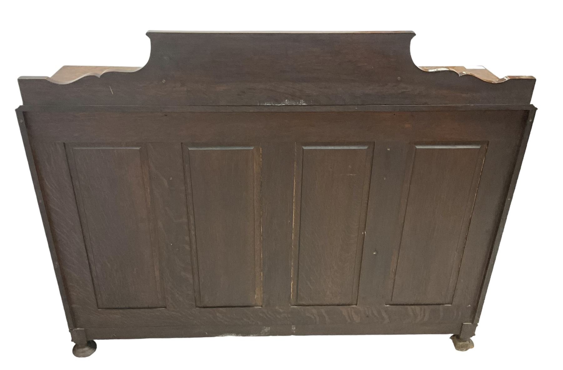 Early 20th century heavily carved oak bookcase bureau, raised back with grape-vine carved frieze, over fall-front enclosing fitted interior, above two short drawers and curved frieze drawer, flanked by astragal glazed and panelled cupboards, on turned feet