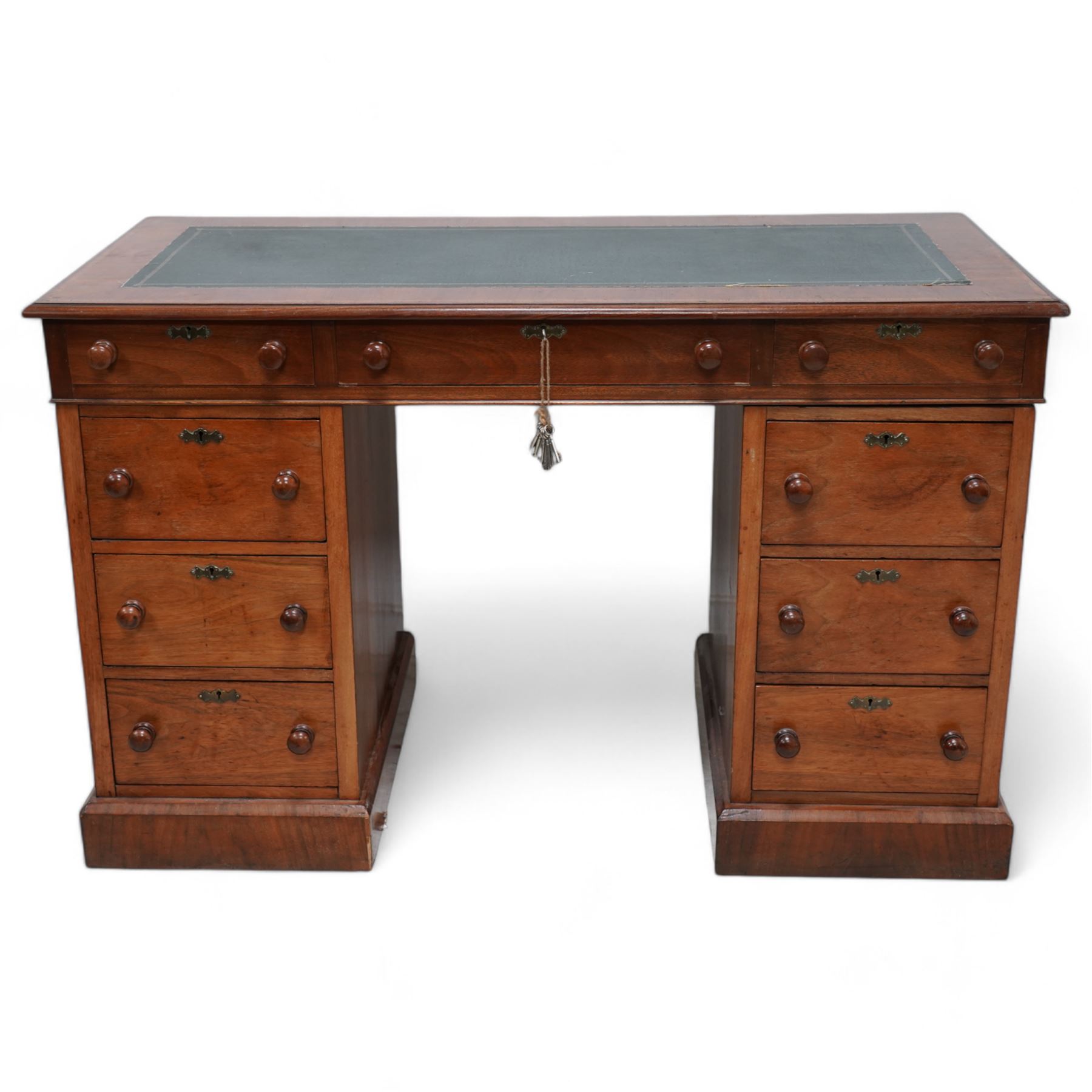 19th century mahogany twin pedestal desk, rectangular top with inset green leather writing surface, fitted with single frieze drawer flanked by four drawers to each side, each with shaped metal escutcheons, on skirted base