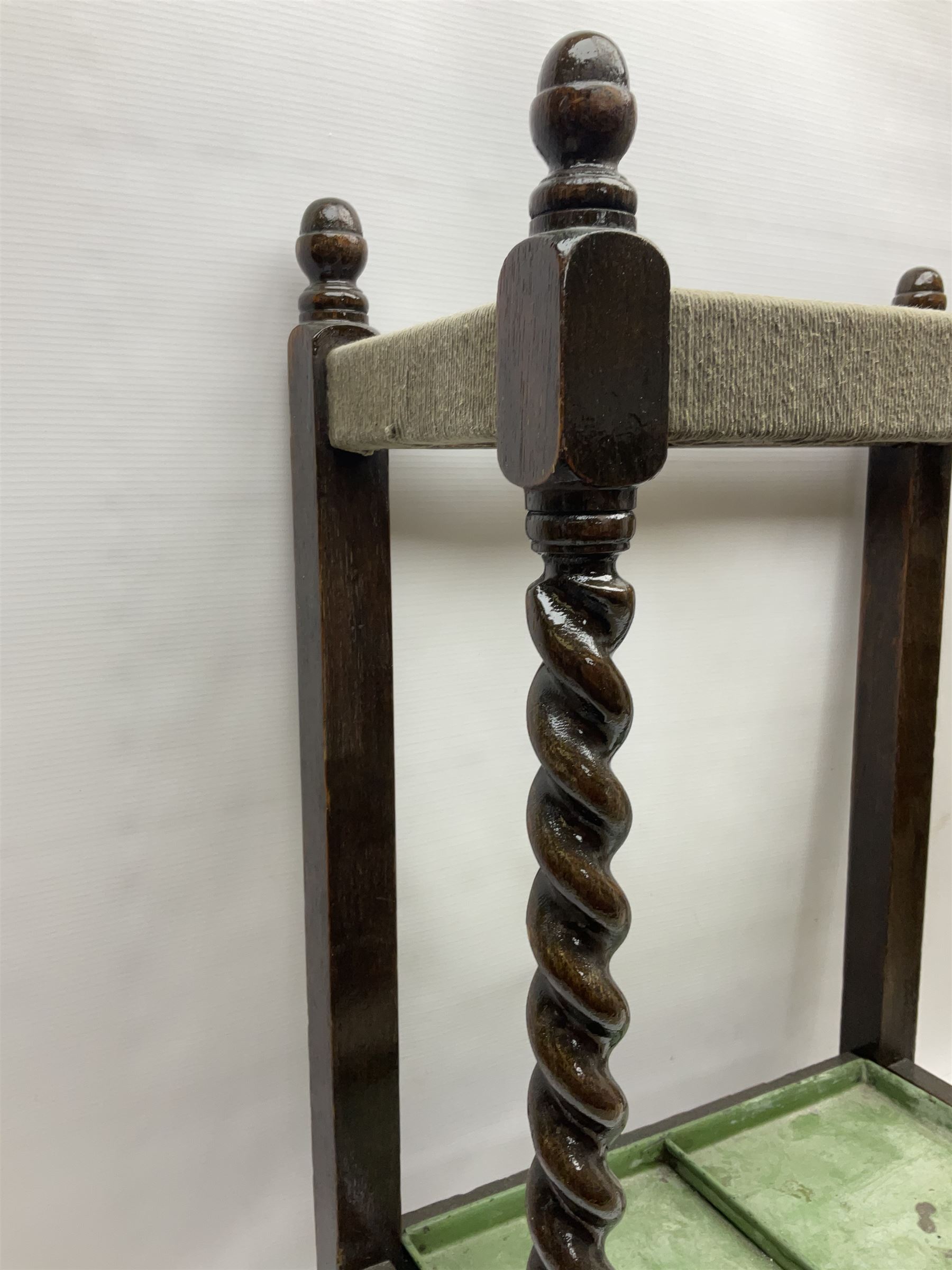 Oak barley twist stick stand, with a collection of walking sticks including examples with carved pommels, horn handles, silver collar etc, together with brass stick stand 