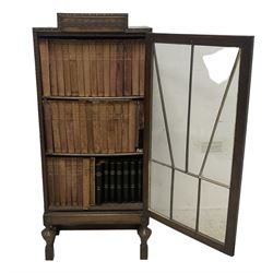 Edwardian oak bookcase, stepped top decorated with beading and stylised floral frieze, single astragal glazed door enclosing encyclopaedias and other books, on turned front feet united by plain stretchers 