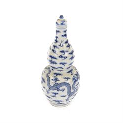 Chinese Kangxi style double-gourd form vase, the blue and white vase surmounted by a domed...