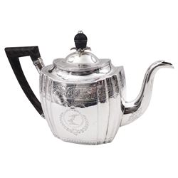 George III silver teapot, of oval form with part faceted sides, wooden handle and finial, the body engraved with central crest and foliate border, hallmarked Duncan Urquhart & Naphtali Hart, London 1799, H16.5cm, approximate gross weight 15.19 ozt (472.5 grams)
