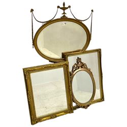 Regency revival style gilt framed oval mirror, the frame with laurel swags topped with urn and flame finial, beaded chain and ram's head motifs, bevelled glass pane; three additional gilt framed mirrors to include one oval and two rectangular (4)