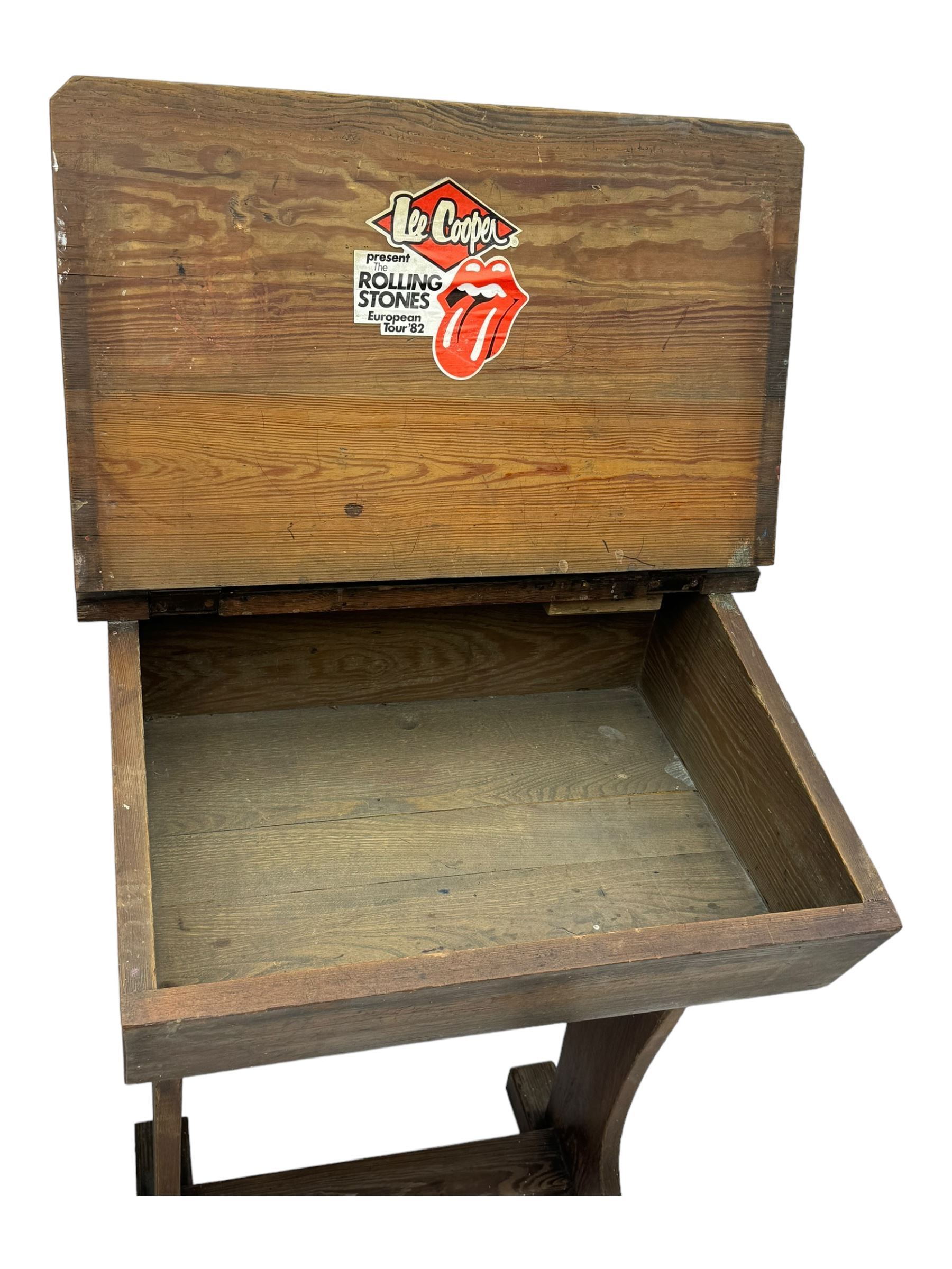 Three pitch pine school desks, each with rectangular lift-top with recessed ink well enclosing storage compartment, on trestle supports joined by stretcher