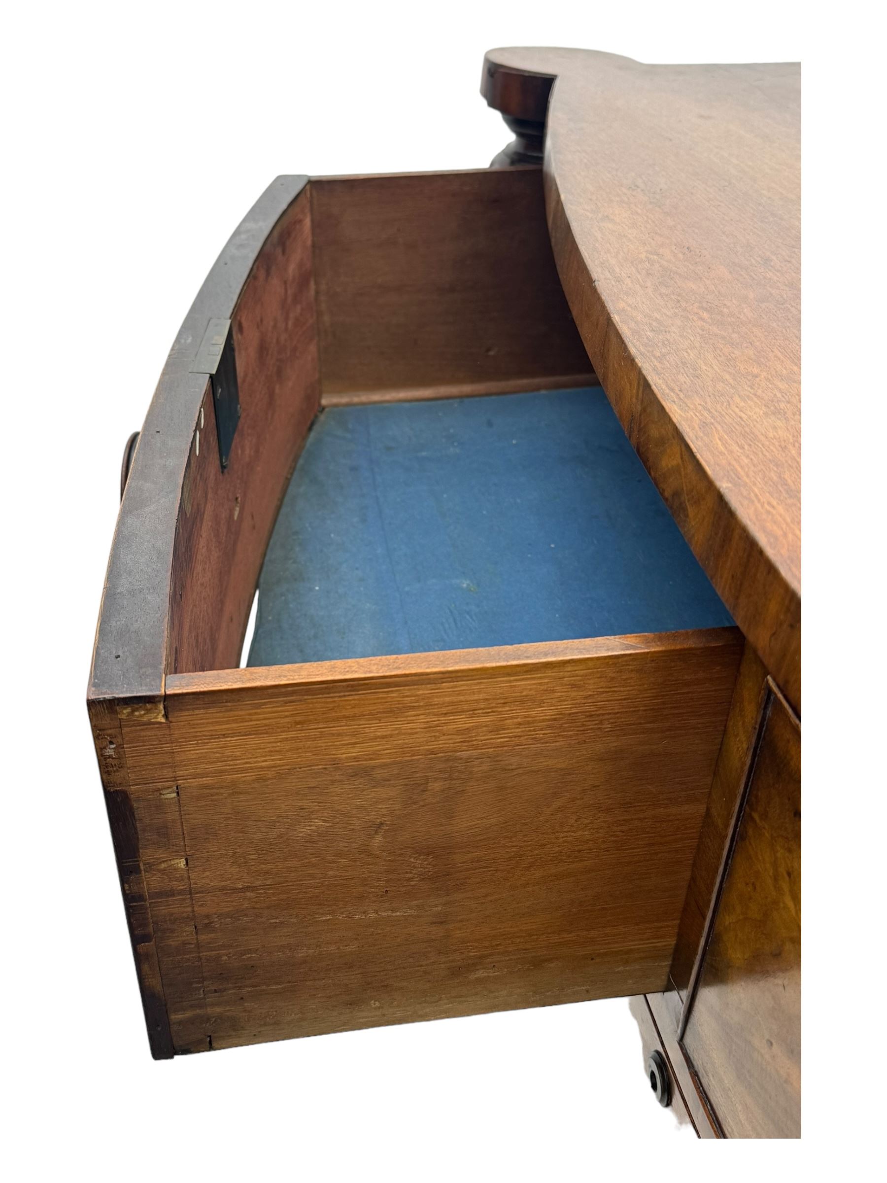 Early Victorian mahogany bow front chest, two short over three long graduating cockbeaded drawers, flanked by faceted columns with carved acanthus leaf capitals, standing on turned bun supports with fluted detailing