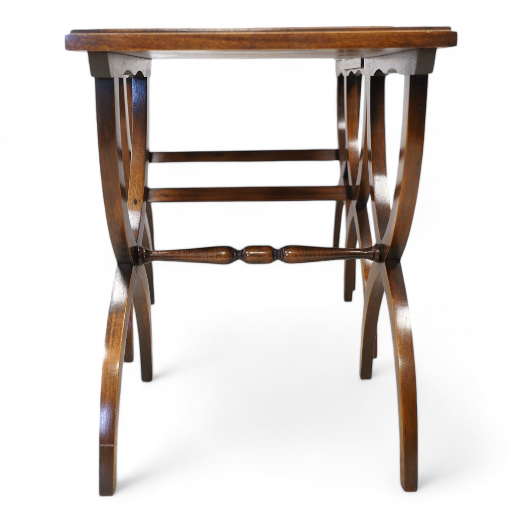 Regency design mahogany nest of three tables, rectangular top with raised lip on curved X-frame supports united by turned stretchers 