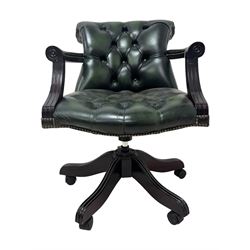 Victorian design Captains swivel desk chair, rolled tub shaped back with open arms, upholstered in deep buttoned green leather with studwork border