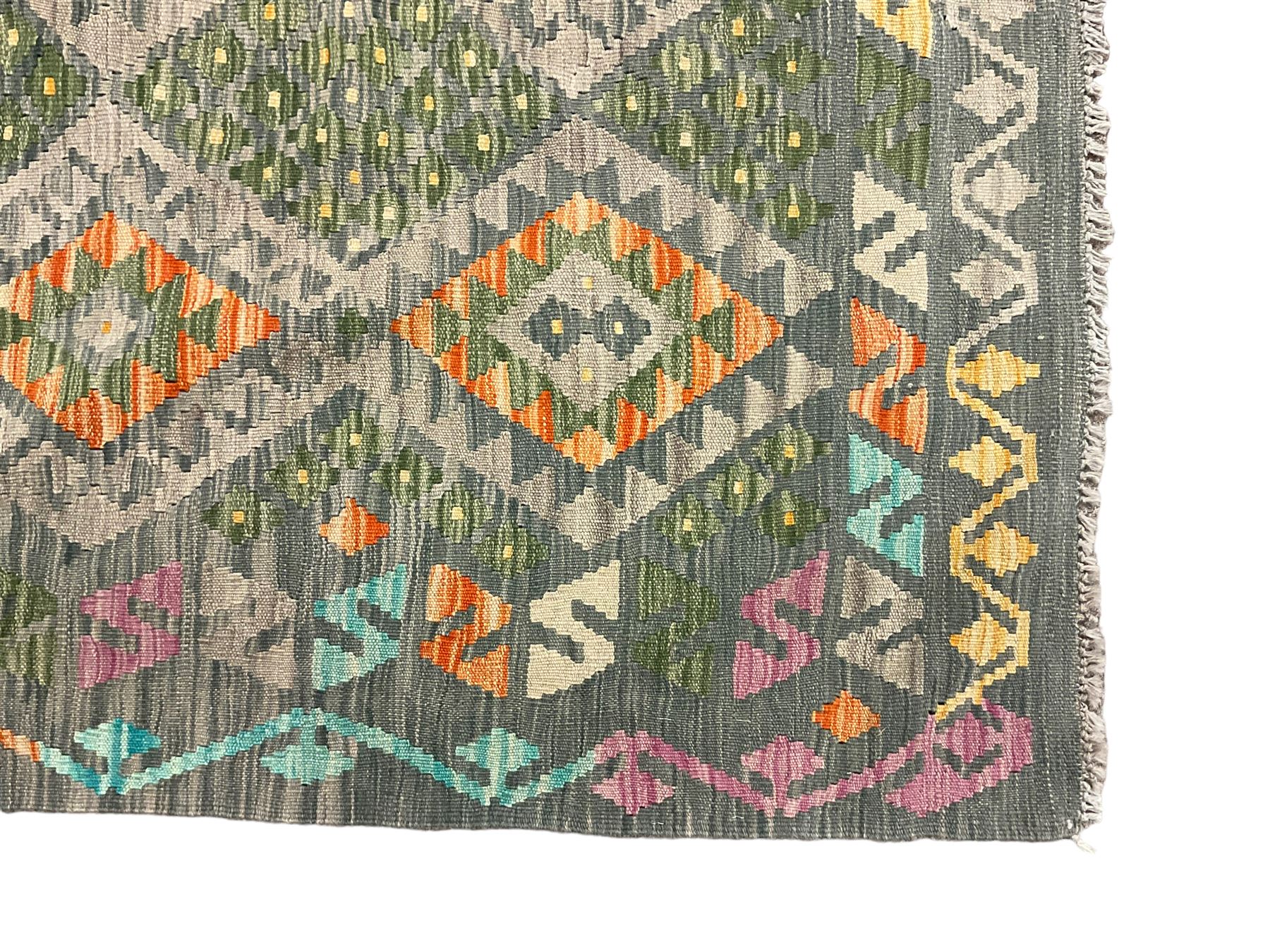 Kilim grey and green ground rug, overall geometric design decorated with lozenges