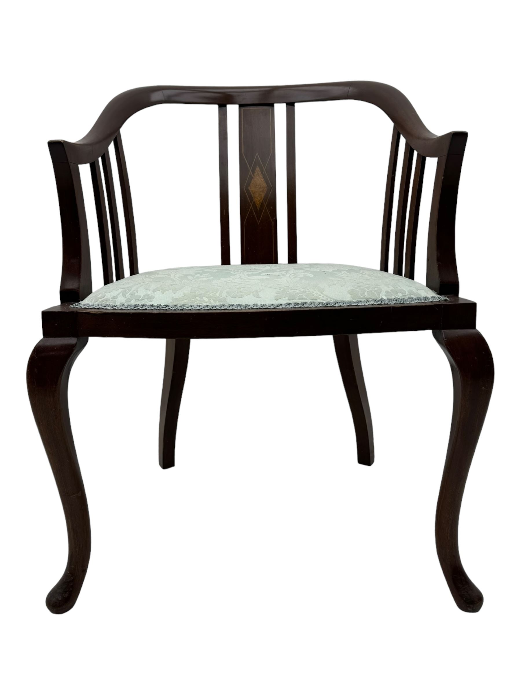 Edwardian inlaid mahogany tub-shaped armchair, curved backrest with inlaid central splat with diamond motif, over padded upholstered seat in pale blue damask fabric, on cabriole supports