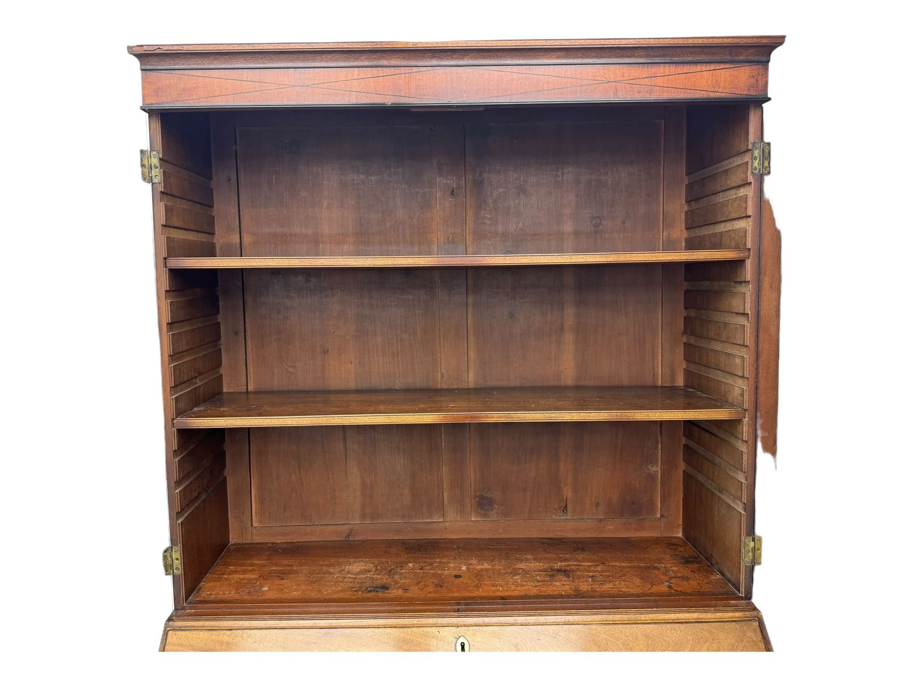 Early 19th century mahogany bureau bookcase, the projecting cornice over two Gothic-style astragal glazed doors enclosing two adjustable shelves, sloped hinged lid enclosing fitted interior and felt inset, four graduating drawers, on bracket feet